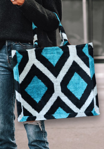 Silk Velvet Ikat Large Tote Bags are crafted with traditional techniques using handwoven ikat weaving, consisting of 75% cocoon silk and 25% organic cotton for durability and a unique design.