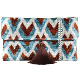 Silk velvet ikat handmade clutch bags, featuring a stylish chain shoulder strap included. Explore our exclusive collection, expertly handcrafted by skilled artisans in Istanbul's Grand Bazaar, Turkey, using traditional Uzbek fabrics. Specially crafted with handwoven silk velvet ikat, each piece showcases vibrant colors and ethnic patterns, accented by special handmade details. Perfect for ethical fashion enthusiasts and holiday shopping, including Valentine's Day gifts, Black Friday sales, discounts, and Mo