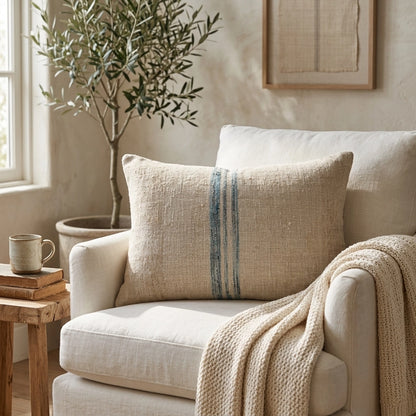 Handmade from authentic antique grain sack linen, this lumbar pillow features a beautiful aqua heritage stripe that brings timeless European farmhouse charm to any interior.
