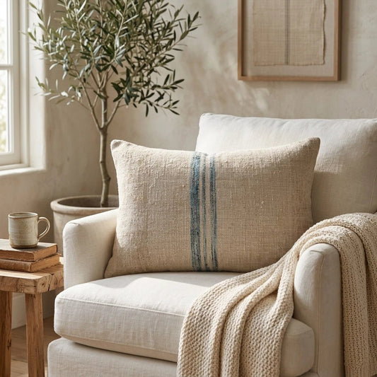 Handmade from authentic antique grain sack linen, this lumbar pillow features a beautiful aqua heritage stripe that brings timeless European farmhouse charm to any interior.