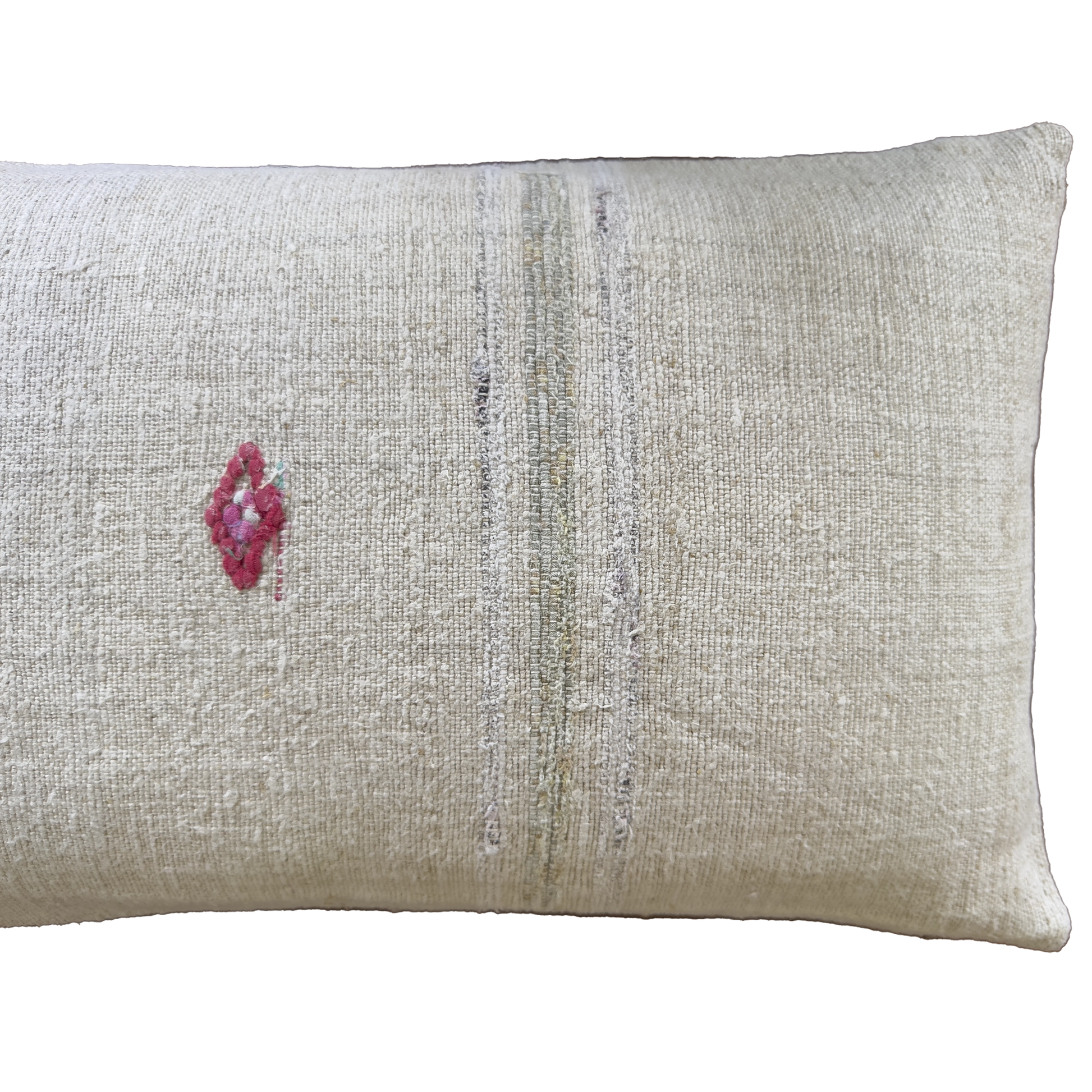 A rectangular beige linen throw pillow with a small pink embroidered diamond on the left and vertical distressed stripes in muted gray and olive tones.