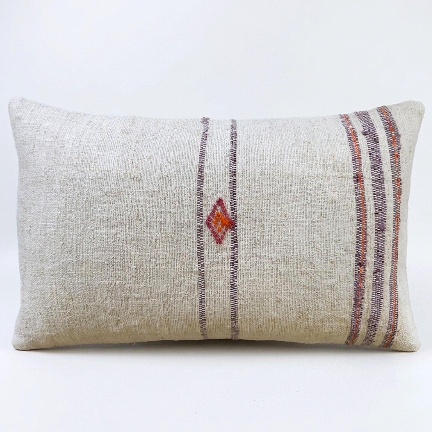 Handcrafted from authentic antique grain sack fabric, this lumbar pillow features soft lavender stripes with a delicate handwoven geometric motif. Its natural linen texture and timeless design bring understated elegance and rustic character to any interior.