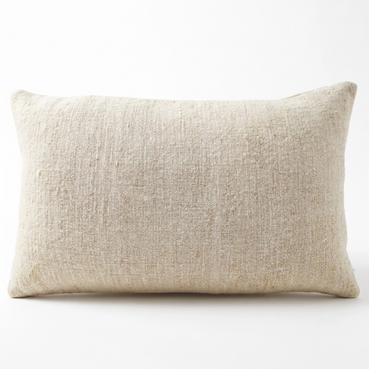 A rectangular lumbar pillow in a textured beige linen fabric, shown against a plain white background.