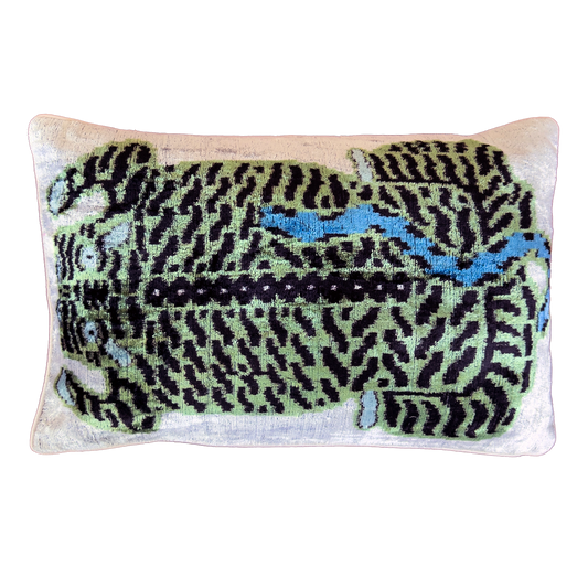 Green leopard silk velvet ikat cushion cover with black and blue details on an ivory velvet background