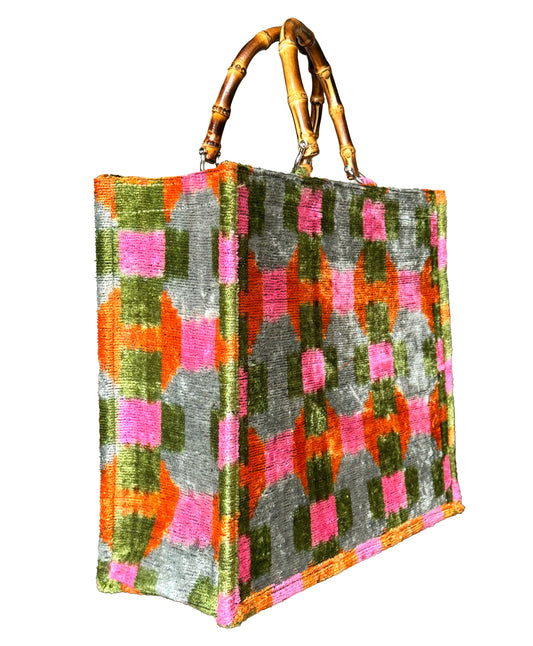 Pink, Orange, and Green Ikat Velvet Tote Bag with a stylish bamboo handle.