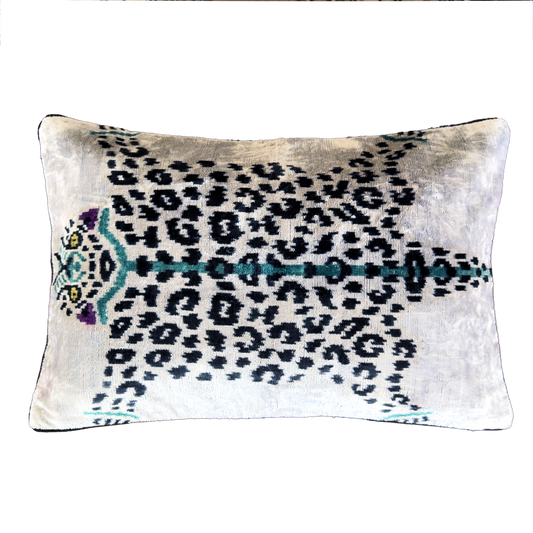 Handmade Royal Snow Leopard silk velvet ikat cushion cover featuring black rosette spots with turquoise, purple and golden accents on an ivory background, 40×60 cm.