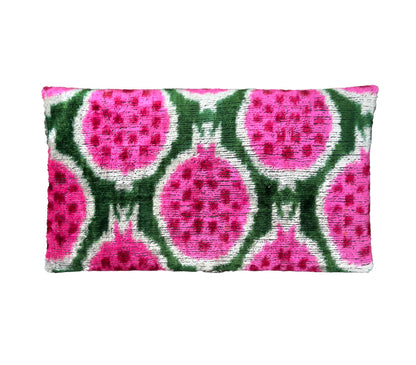 Silk velvet ikat clutch with pink and green pattern on a white background
