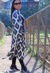 Get ready for Black Friday with our exquisite handwoven silk ikat caftan, a perfect ikat dress for gifting. Crafted using traditional Uzbekistan ikat woven techniques, this stunning ikat wear features bell sleeves, side and sleeve slits, and pockets on both sides. Available in elegant black and grey, this ikat caftan beautifully blends bohemian style with ethnic charm, making it the ideal gift for anyone who appreciates unique ikat fashion. Embrace the artistry of handmade ikat clothing and make a statement