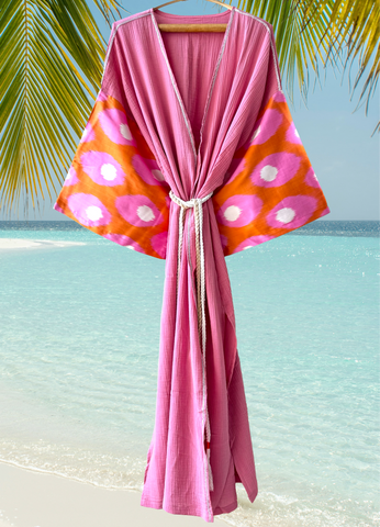 Luxury Silk Ikat Muslin Robe. Lightweight, quick-dry, pink & orange Ikat silk detailed beach cover-up. Wear as a resort kaftan or stylish light layering piece over clothes.