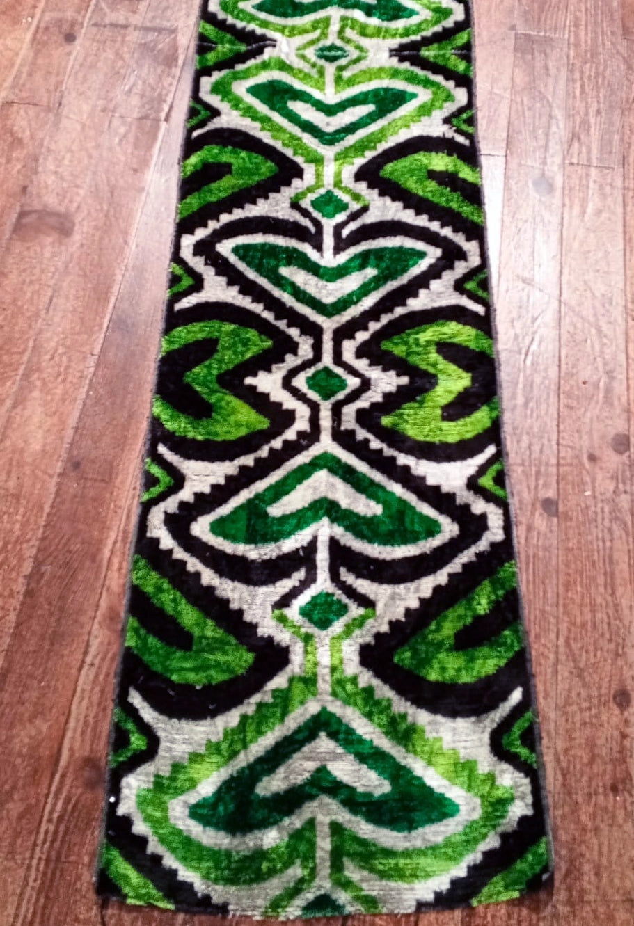 This Silk Velvet Ikat Handwoven Fabric in black and green features unique geometric patterns created through traditional weaving techniques. With its luxurious velvet texture and rich hues, this handcrafted fabric offers exceptional quality, perfect for fashion or home decor. Limited production ensures exclusivity, adding timeless elegance to any design.