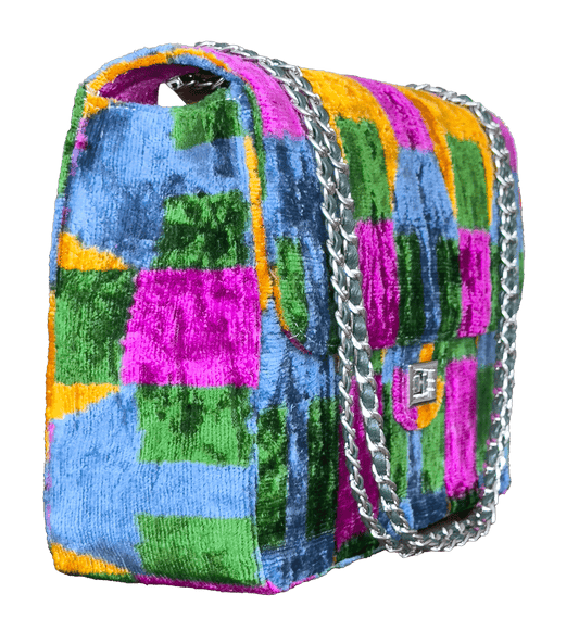 Silk velvet ikat jumbo Multicolored checkered handbag with a silver chain on a white background