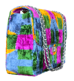 Silk velvet ikat jumbo Multicolored checkered handbag with a silver chain on a white background