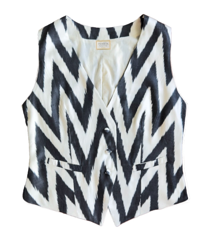 Black and white zigzag patterned silk ikat vest on a white background