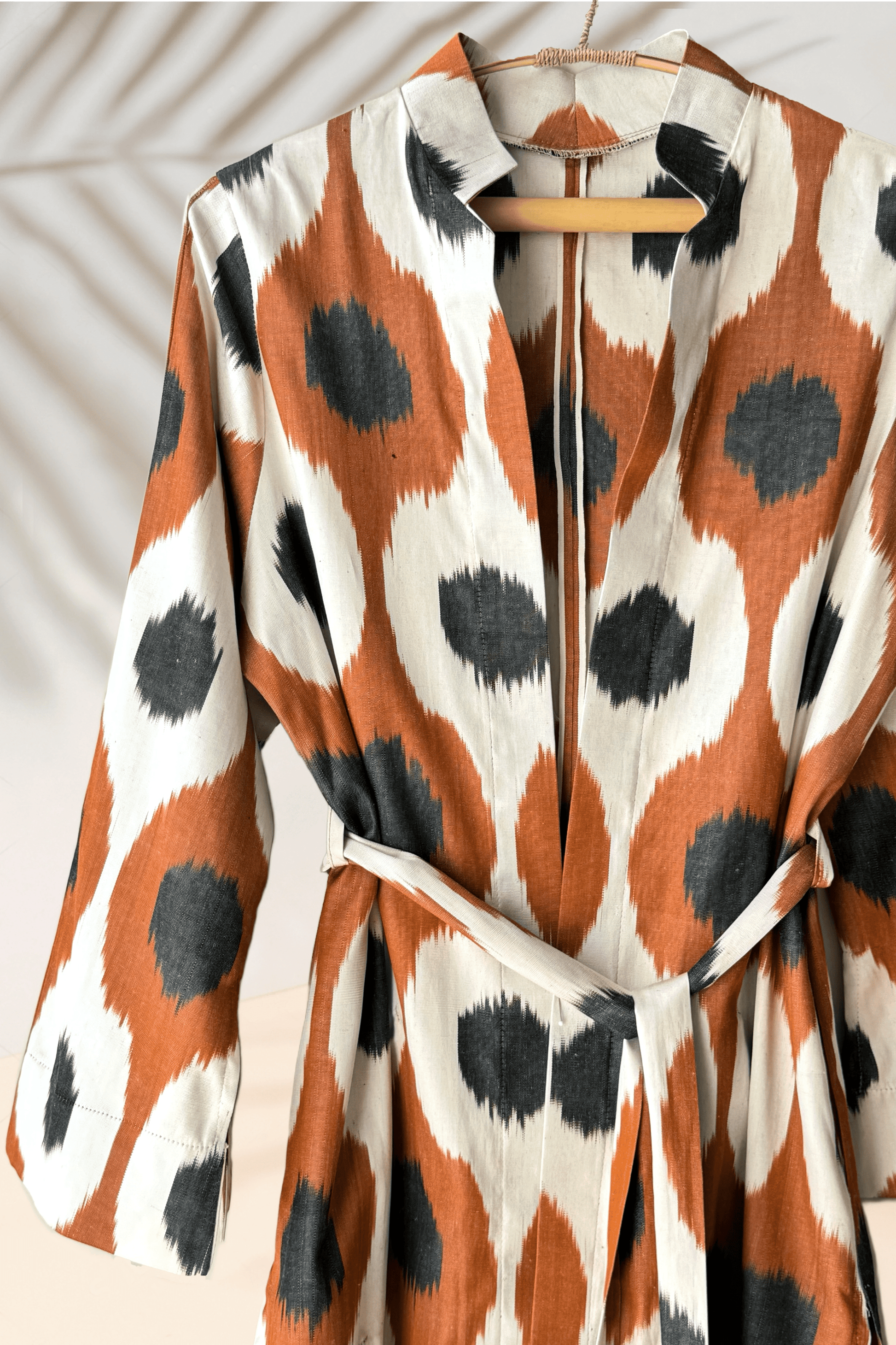 handwoven silk ikat caftan, a perfect ikat dress for gifting. Crafted using traditional Uzbekistan ikat woven techniques, this stunning ikat wear features bell sleeves, side and sleeve slits, and pockets on both sides. Available in elegant black and grey, this ikat caftan beautifully blends bohemian style with ethnic charm, making it the ideal gift for anyone who appreciates unique ikat fashion. Embrace the artistry of handmade ikat clothing and make a statement