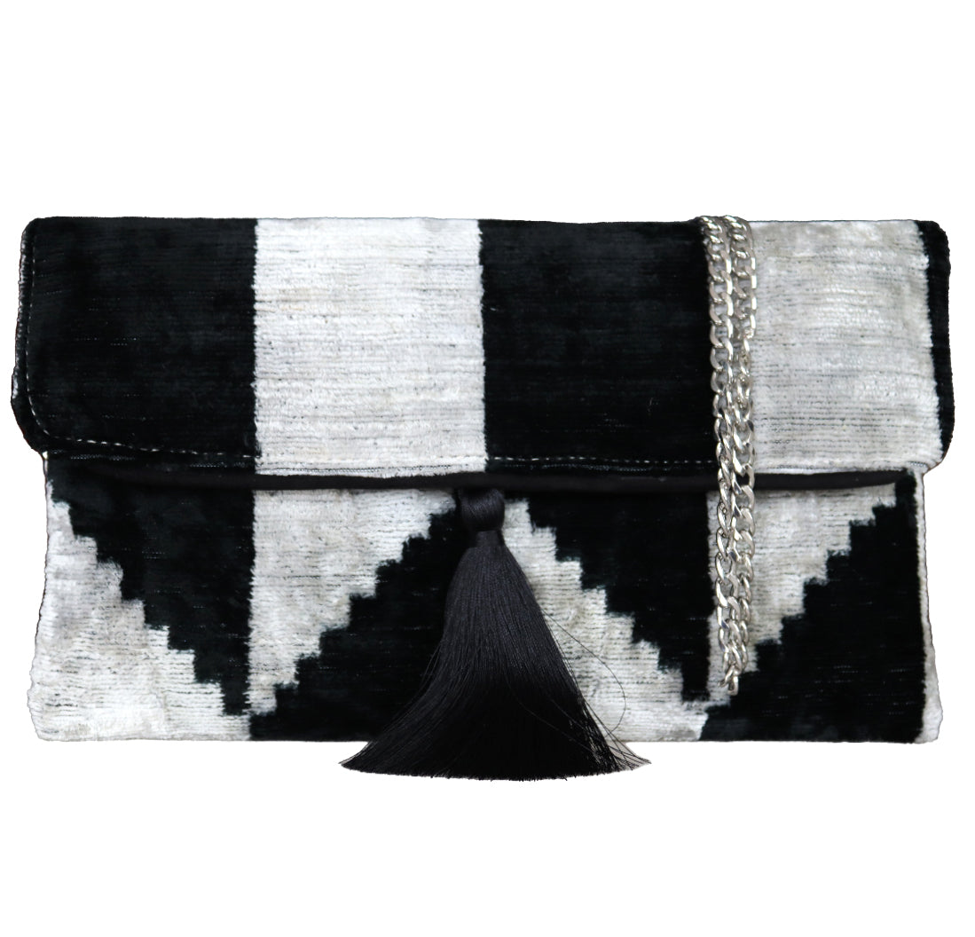 black and white silk velvet clutch bag.Wholesale and retail Silk İkat Velvet Clutch Bags, expertly handcrafted using traditional Uzbek fabrics. Explore our exclusive collection of unique clutch bags, specially crafted using handwoven silk velvet ikat with vibrant colors and ethnic patterns. Each one carries its own uniqueness, accentuated by special handmade details. Produced by skilled artisans in Istanbul's Grand Bazaar, Turkey, these bags are perfect for ethical fashion enthusiasts 