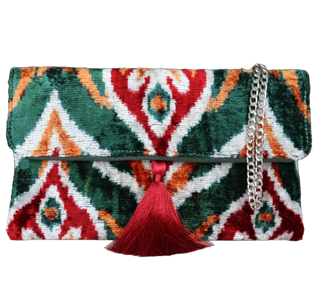 Wholesale clutch bags supplier, offering green, red, Silk Velvet Ikat handmade clutch bags with a stylish chain shoulder strap included. Explore our exclusive collection, expertly handcrafted by skilled artisans in Istanbul's Grand Bazaar, Turkey, using traditional Uzbek fabrics. Specially crafted with handwoven silk velvet ikat, each piece showcases vibrant colors and ethnic patterns, accented by special handmade details. Perfect for ethical fashion enthusiasts and holiday shopping, 